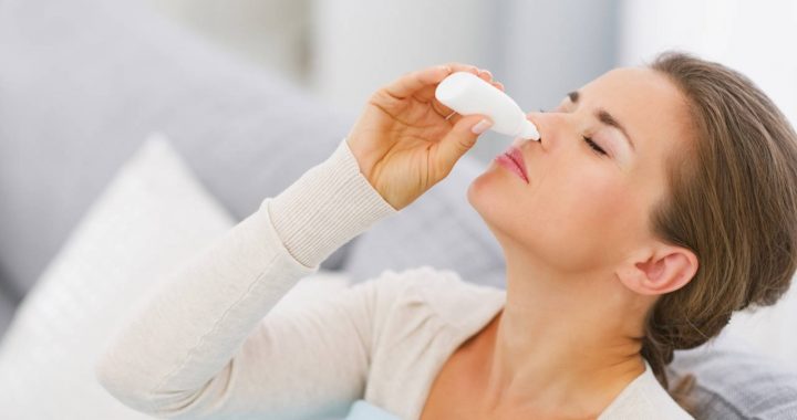 young woman using nose drops